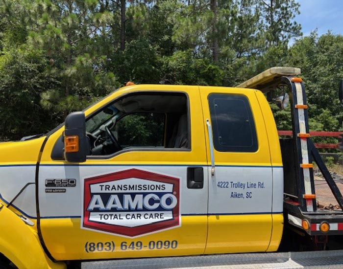 AAMCO Transmissions Total Car Care yellow tow truck